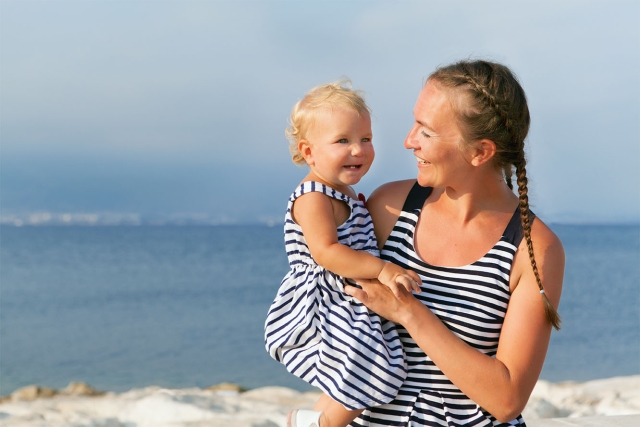 Happy mother with child on the beach