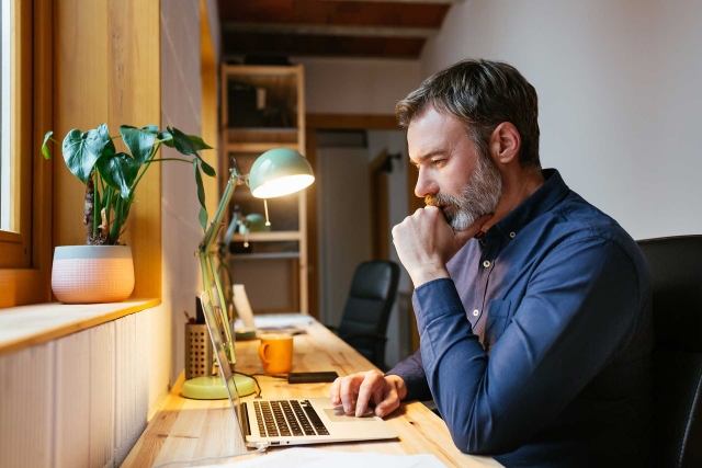 Man reading news on laptop