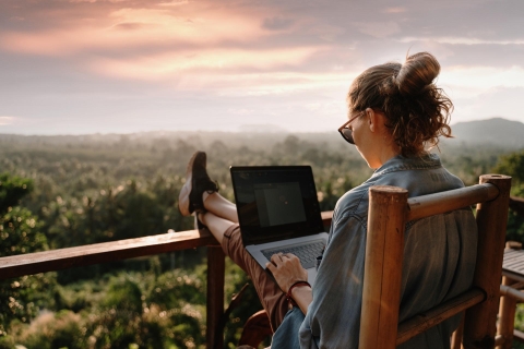 Young woman with laptop in the mountains