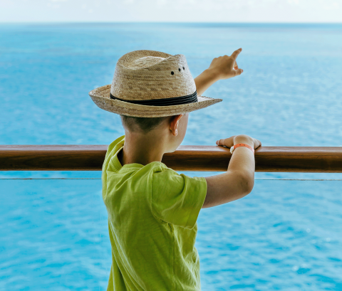 Boly pointing to the ocean from a boat