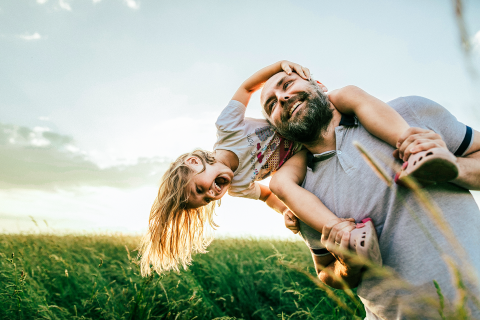 Father and daughter playing in a field