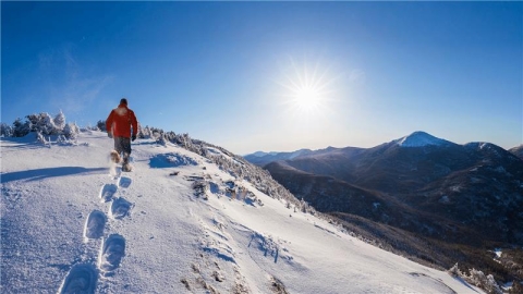 Person walking on snowy mountain